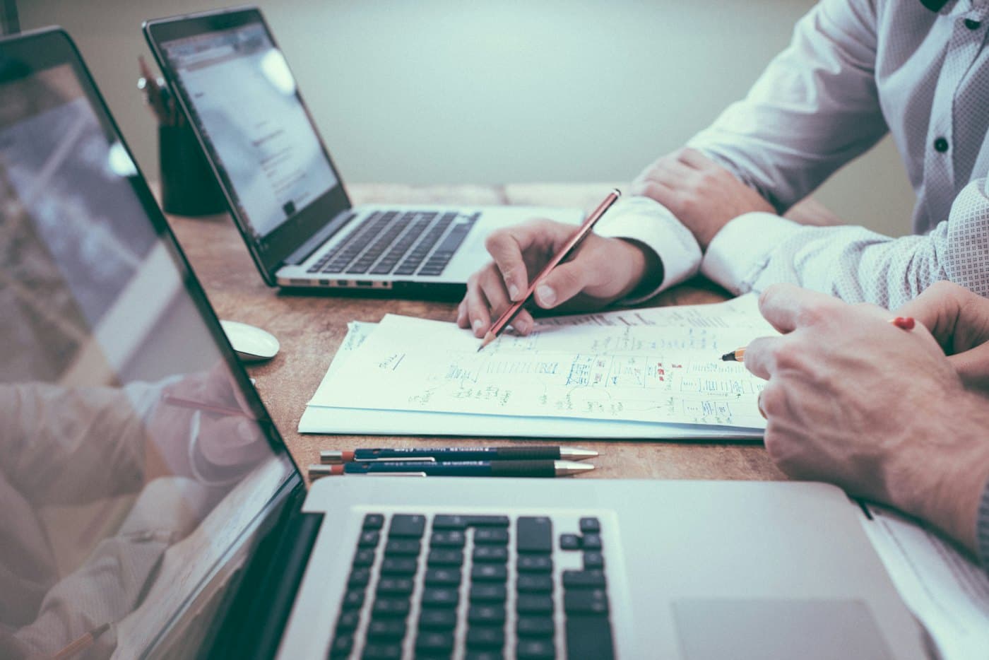 Executives reviewing documents and figures at a desk